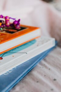 Artistic close-up of colorful children's books stacked with toys, ideal for educational themes.